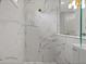 Modern shower featuring white marble tile and gold fixtures creating a luxurious bathing experience at 13319 Deep Blue Pl, Bradenton, FL 34211