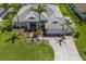 Aerial view of home with mature trees, tropical landscaping, tile roof and paver driveway at 14210 9Th Ne Ter, Bradenton, FL 34212