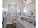 Bright bathroom with a marble vanity, sleek fixtures, a glass-enclosed shower, and elegant nautical-themed decorations at 14210 9Th Ne Ter, Bradenton, FL 34212