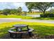 Scenic community view featuring a picnic table with a lake and luxurious homes in the background at 14210 9Th Ne Ter, Bradenton, FL 34212