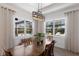 Cozy dining room with an elegant table set, natural light, and views of the pool at 14210 9Th Ne Ter, Bradenton, FL 34212