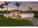 Charming home featuring a manicured lawn, lush landscaping, and a three-car garage at 14210 9Th Ne Ter, Bradenton, FL 34212