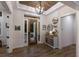 Elegant foyer featuring a tray ceiling, wood-look tile flooring, and console table at 14210 9Th Ne Ter, Bradenton, FL 34212