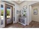 Stylish foyer with decorative console table, wood-look tile flooring, and natural light at 14210 9Th Ne Ter, Bradenton, FL 34212