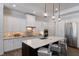 Modern kitchen featuring custom cabinets, quartz countertops, and stainless steel appliances at 14210 9Th Ne Ter, Bradenton, FL 34212