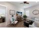 Open-concept living area with stylish furniture, including a white chair and light blue sectional sofa, plus beach-themed decor at 14210 9Th Ne Ter, Bradenton, FL 34212