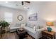 Comfortable living room featuring a light blue sectional sofa, ottoman, decorative mirror and coastal artwork at 14210 9Th Ne Ter, Bradenton, FL 34212