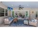 Covered patio with outdoor seating, a ceiling fan, and a TV, offering a comfortable entertainment space at 14210 9Th Ne Ter, Bradenton, FL 34212