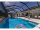 Inviting screened-in pool area with lounge chairs, a dining table, and clear blue water for relaxation and entertainment at 14210 9Th Ne Ter, Bradenton, FL 34212