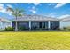 Spacious backyard with lush lawn and landscaping enhance the exterior of this charming single Gathering home at 16148 Preservation Blvd, Punta Gorda, FL 33982