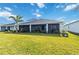 Exterior view of the home showcasing the lush green backyard with a well-maintained lawn and landscaping at 16148 Preservation Blvd, Punta Gorda, FL 33982
