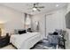 Cozy bedroom featuring a comfortable bed, reading chair, and storage closet at 16148 Preservation Blvd, Punta Gorda, FL 33982