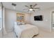 Cozy bedroom featuring a comfortable bed, ceiling fan, and modern decor at 16148 Preservation Blvd, Punta Gorda, FL 33982