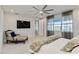 Spacious bedroom with a ceiling fan, chair and beautiful lake view at 16148 Preservation Blvd, Punta Gorda, FL 33982