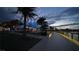 A scenic boardwalk alongside a waterfront restaurant with outdoor seating and beautiful sunset views at 16148 Preservation Blvd, Punta Gorda, FL 33982