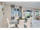 Bright dining room featuring a glass table, white chairs, and a view of the lake at 16148 Preservation Blvd, Punta Gorda, FL 33982
