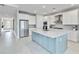 Modern kitchen with stainless steel appliances, a large island, and white cabinetry at 16148 Preservation Blvd, Punta Gorda, FL 33982