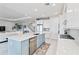 Bright kitchen with a quartz island, stainless steel appliances, and an open layout at 16148 Preservation Blvd, Punta Gorda, FL 33982