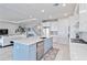 Modern kitchen featuring a large island with stainless steel appliances and ample cabinet space at 16148 Preservation Blvd, Punta Gorda, FL 33982