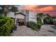 Exterior view of The Lake House Kitchen & Bar with charming architecture and a welcoming entrance at dusk at 16148 Preservation Blvd, Punta Gorda, FL 33982