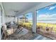 Covered lanai with outdoor seating and scenic lake views, perfect for relaxing at 16148 Preservation Blvd, Punta Gorda, FL 33982