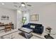 Bright living area featuring modern decor, a stylish sofa, and an elegant workstation at 16148 Preservation Blvd, Punta Gorda, FL 33982