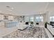Open-concept living space with a lake view, white sofa, and modern decor at 16148 Preservation Blvd, Punta Gorda, FL 33982