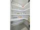 Spacious walk-in pantry with ample shelving for organized storage at 16148 Preservation Blvd, Punta Gorda, FL 33982