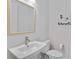 Modern powder room featuring a sleek sink, stylish mirror, and contemporary fixtures at 16148 Preservation Blvd, Punta Gorda, FL 33982
