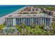 Aerial view of condo building with pool, landscaping, beach access, and ocean view at 1701 Gulf Of Mexico Dr # 502, Longboat Key, FL 34228