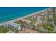 Beautiful aerial view of the beachfront condo complex with a pristine sandy beach and blue ocean waters at 1701 Gulf Of Mexico Dr # 502, Longboat Key, FL 34228