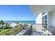 Scenic balcony view overlooking the sandy beach, turquoise water, and lush landscaping for serene outdoor enjoyment at 1701 Gulf Of Mexico Dr # 502, Longboat Key, FL 34228