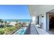 Beautiful balcony view overlooking the beach, palm trees, and a community pool for relaxing outdoor living at 1701 Gulf Of Mexico Dr # 502, Longboat Key, FL 34228