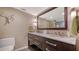 Elegant bathroom featuring double sinks, marble countertops, modern fixtures and a large mirror at 1701 Gulf Of Mexico Dr # 502, Longboat Key, FL 34228