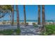Beach access with bench and walking path that features palm trees and ocean views at 1701 Gulf Of Mexico Dr # 502, Longboat Key, FL 34228