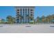 Stunning beachfront condo building featuring direct access to the sandy beach and lounge chairs with umbrellas at 1701 Gulf Of Mexico Dr # 502, Longboat Key, FL 34228