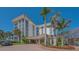 Striking building exterior featuring an elegant entrance, lush landscaping, and beautiful brick driveways at 1701 Gulf Of Mexico Dr # 502, Longboat Key, FL 34228
