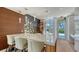 Common area with a marble-top island, modern lighting, wood floors and a stylish shelving unit at 1701 Gulf Of Mexico Dr # 502, Longboat Key, FL 34228