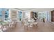 Community common area featuring tables, chairs, hardwood floors and plenty of natural light at 1701 Gulf Of Mexico Dr # 502, Longboat Key, FL 34228