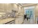 Modern kitchen with stainless steel appliances, granite countertops and a mosaic tile backsplash at 1701 Gulf Of Mexico Dr # 502, Longboat Key, FL 34228