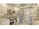 Bright kitchen featuring stainless steel appliances, light wood floors, and granite countertops at 1701 Gulf Of Mexico Dr # 502, Longboat Key, FL 34228