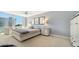 Bedroom features carpet floors, a ceiling fan, a window with a view, and modern furnishings at 1701 Gulf Of Mexico Dr # 502, Longboat Key, FL 34228