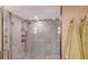 Stylish shower featuring mosaic tile walls, glass door, and modern shower fixtures at 1701 Gulf Of Mexico Dr # 502, Longboat Key, FL 34228