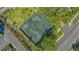Aerial view of well-maintained tennis courts surrounded by lush greenery and trees at 1701 Gulf Of Mexico Dr # 502, Longboat Key, FL 34228