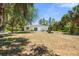 Spacious backyard featuring lush tropical landscaping and patio at 1709 Kerman St, North Port, FL 34288