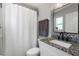 Bathroom with granite countertop and a white shower curtain at 1709 Kerman St, North Port, FL 34288