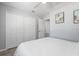 Bedroom with a large closet, neutral walls, ceiling fan, and an open doorway to another room at 1709 Kerman St, North Port, FL 34288