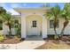 Inviting front entrance with arched doorway and tropical landscaping at 1709 Kerman St, North Port, FL 34288