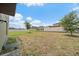 Large backyard with a grass area, a metal garden bed, and a privacy fence at 1723 Fred Ives St, Ruskin, FL 33570
