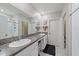 Bathroom featuring dual sinks, a spacious mirror, granite countertops, and stylish accents for a modern aesthetic at 1723 Fred Ives St, Ruskin, FL 33570